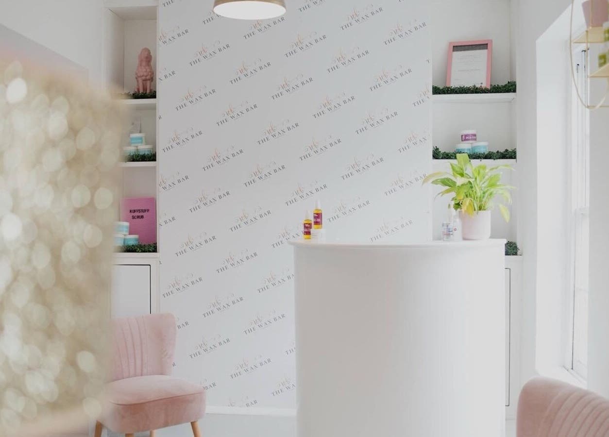 Bright reception area at Magi Brows & Lashes, Norwich, England, GB with sleek decor and lush greenery.