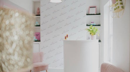 Bright reception area at Magi Brows & Lashes, Norwich, England, GB with sleek decor and lush greenery.