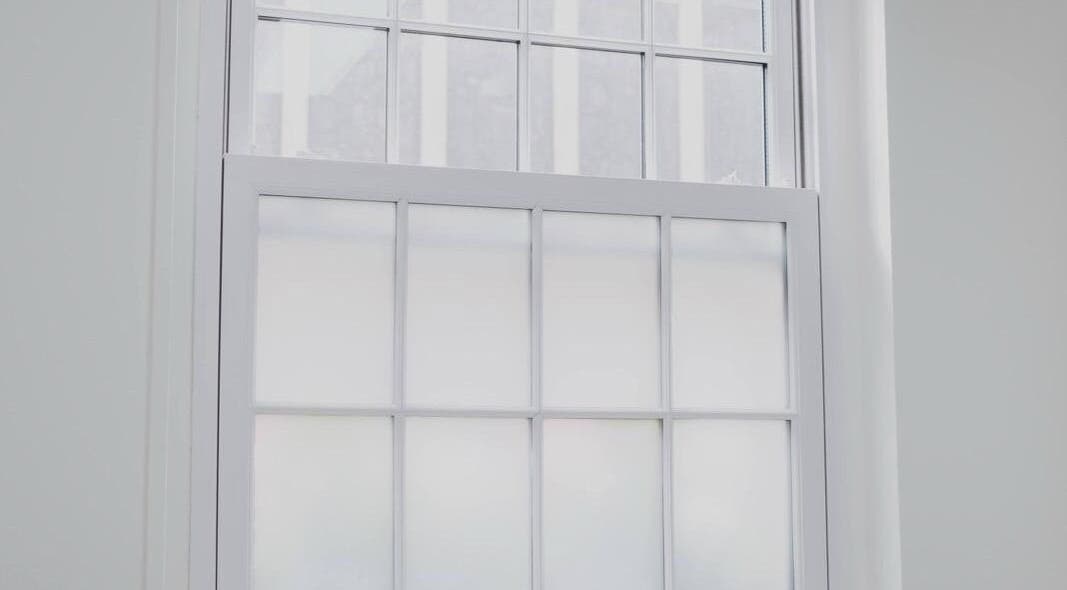 Bright window at Magi Brows & Lashes in Norwich, England, GB illuminating the wellness space.