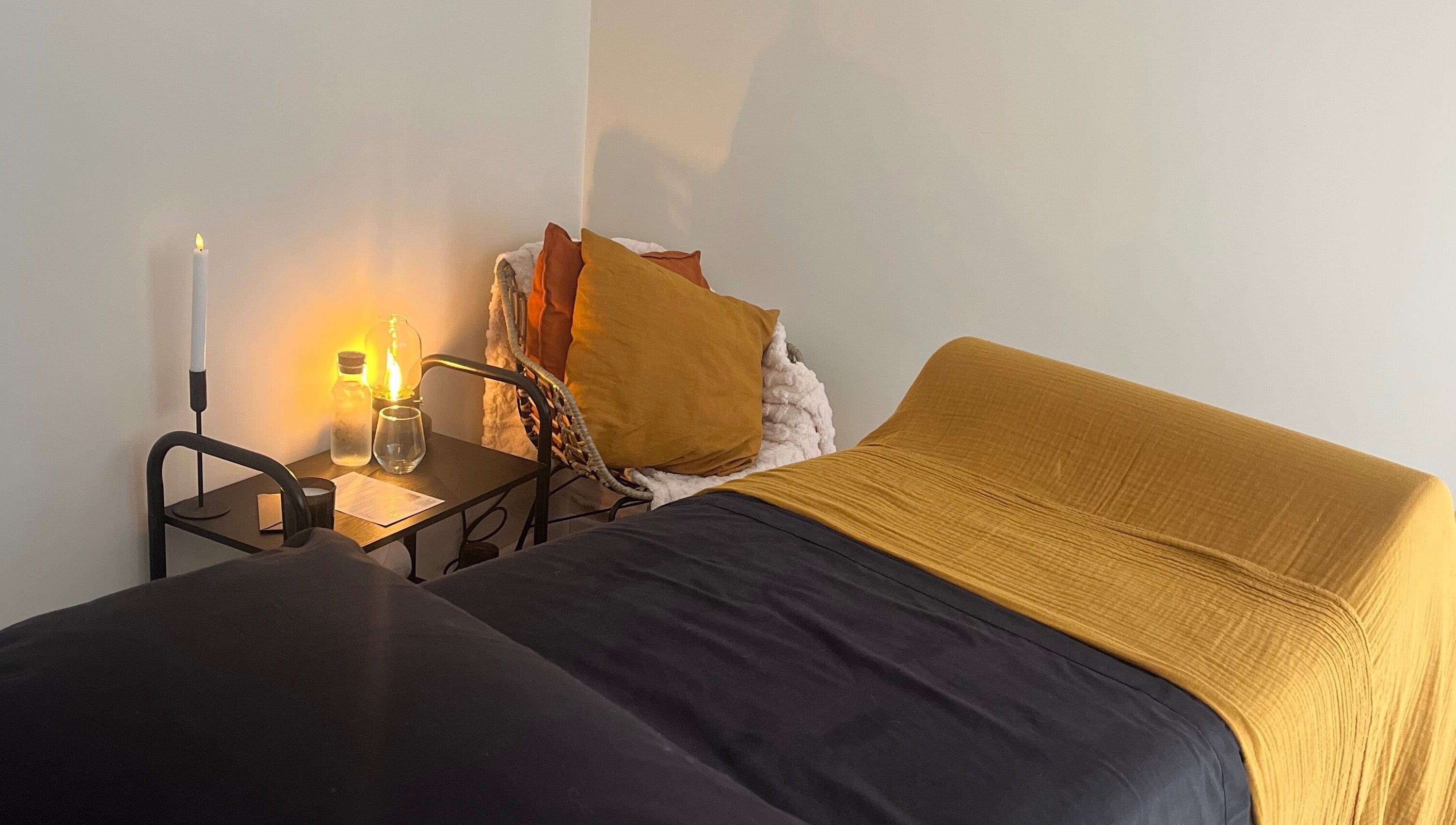 Relaxing treatment room at The Secret Retreat, Longridge, England, GB, with ambient lighting and plush bedding.