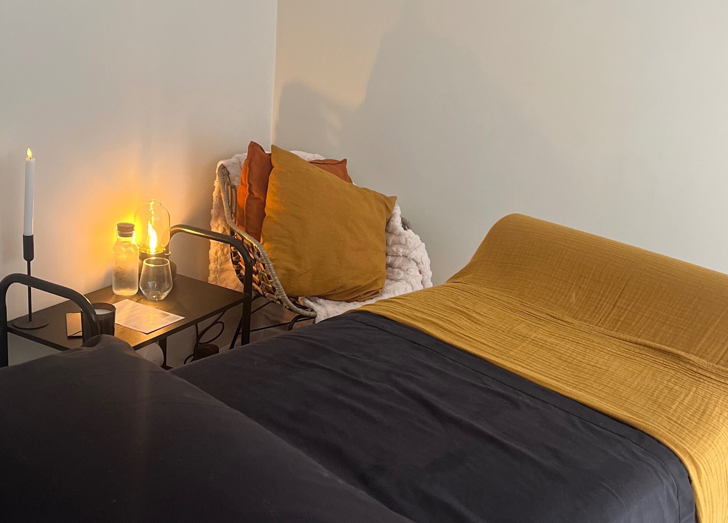 Relaxing treatment room at The Secret Retreat, Longridge, England, GB, with ambient lighting and plush bedding.