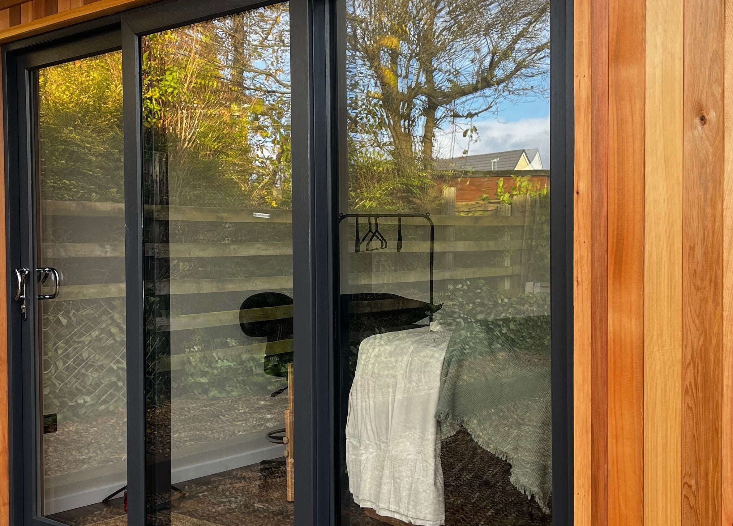 Glass door entry at The Secret Retreat in Longridge, England, GB, showcasing a serene garden view.
