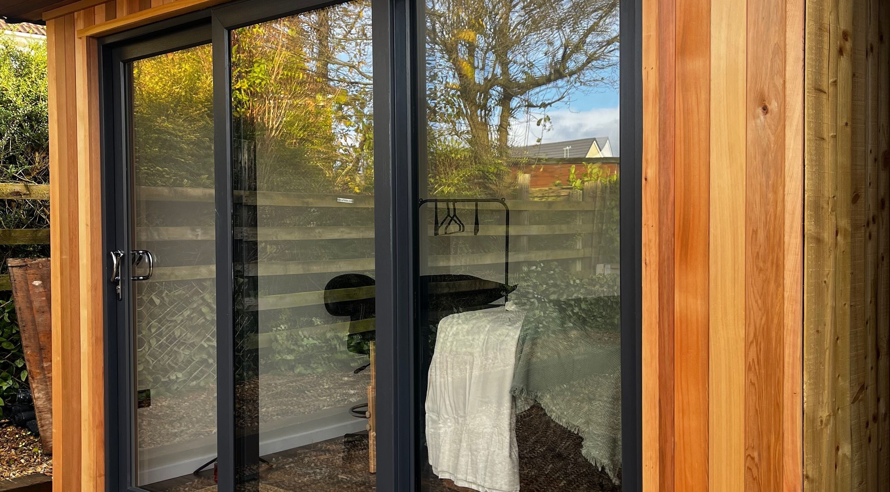 Glass door entry at The Secret Retreat in Longridge, England, GB, showcasing a serene garden view.