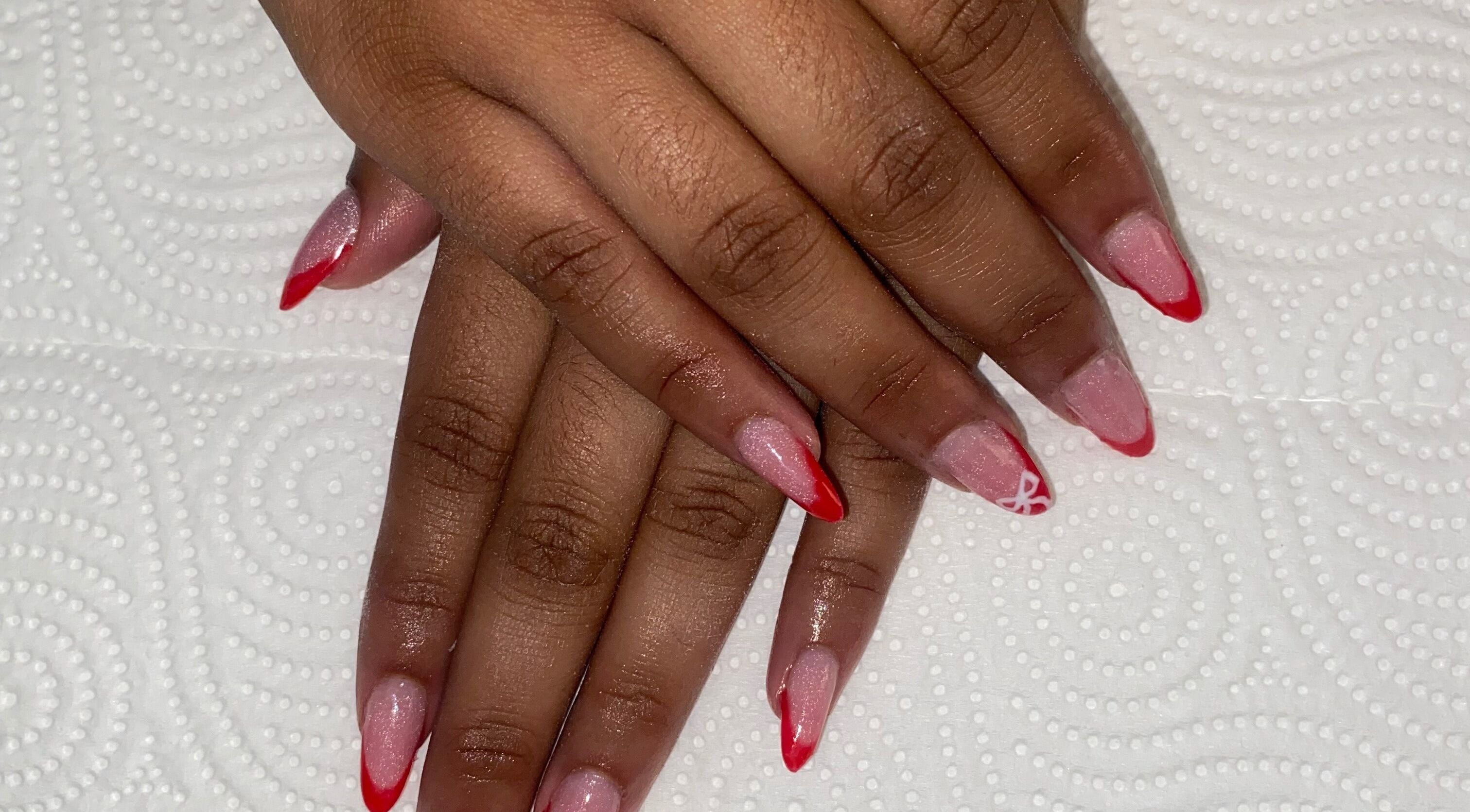 Beautiful red-tipped nails at Claws & Effect in Randburg, Gauteng, ZA showcased on elegant hands.