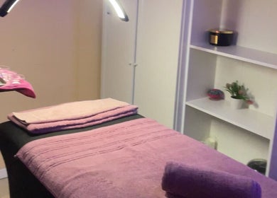 Sala de masajes en DB Beauty, Madrid, Comunidad De Madrid, ES con toallas rosadas y ambiente acogedor.