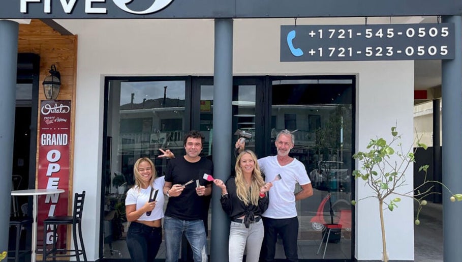 Team celebrating The Five's grand opening at Saint Martin, MF with joyful smiles and open doors.