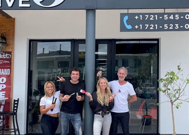 Team celebrating The Five's grand opening at Saint Martin, MF with joyful smiles and open doors.