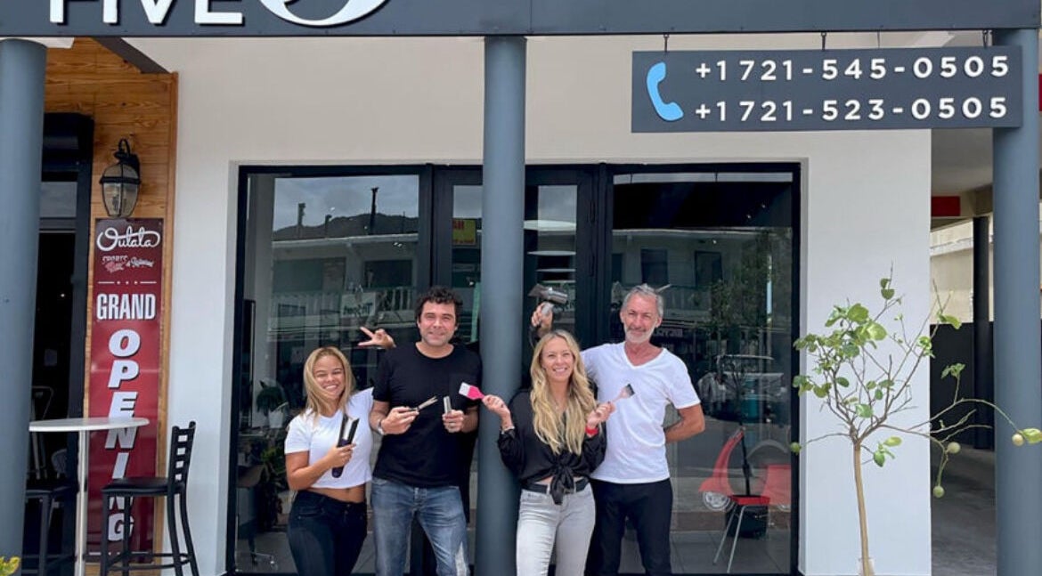 Team celebrating The Five's grand opening at Saint Martin, MF with joyful smiles and open doors.