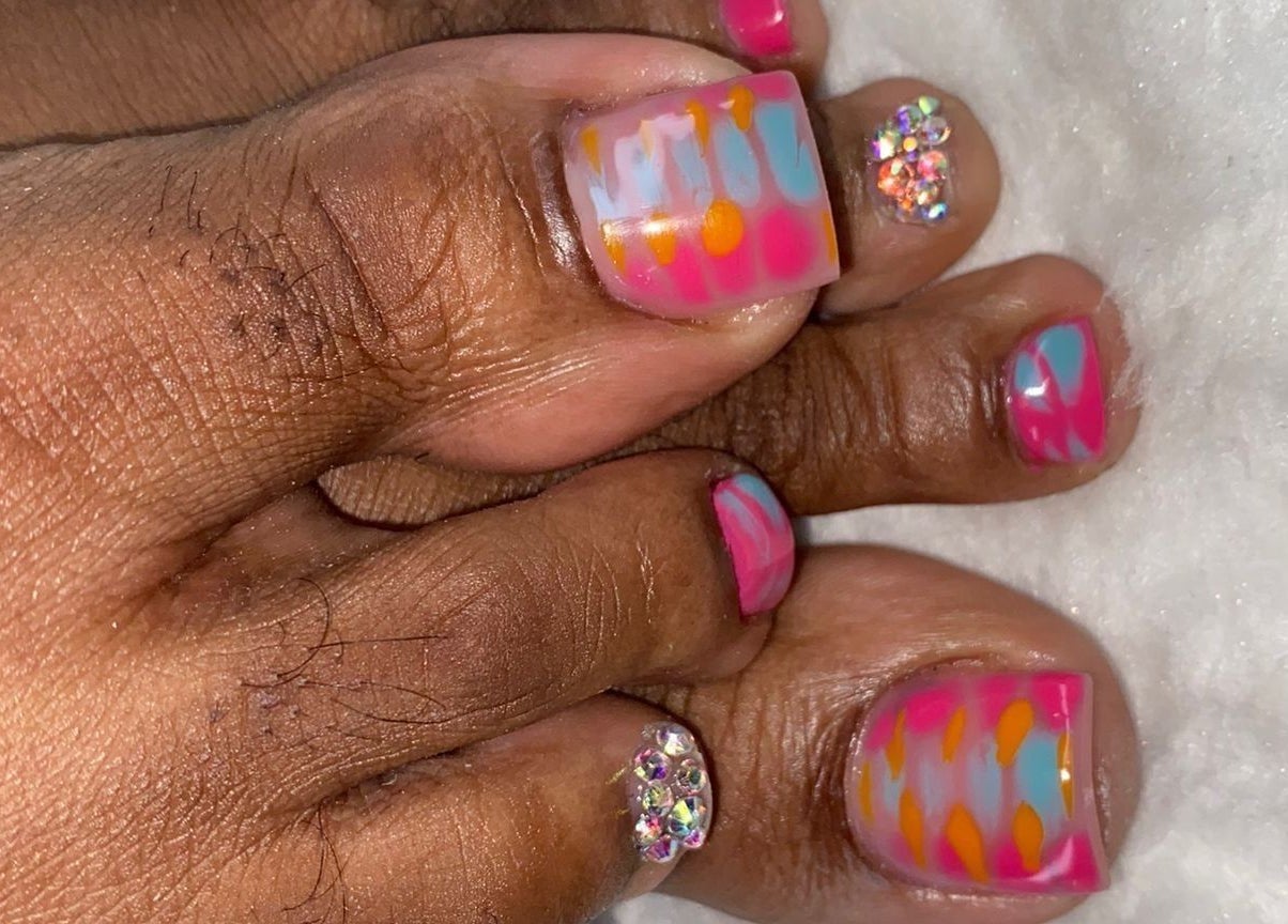 Colorful toenail art at Ccallicosmetics in Speightstown, Saint Peter, BB, featuring pink, orange, and blue designs.
