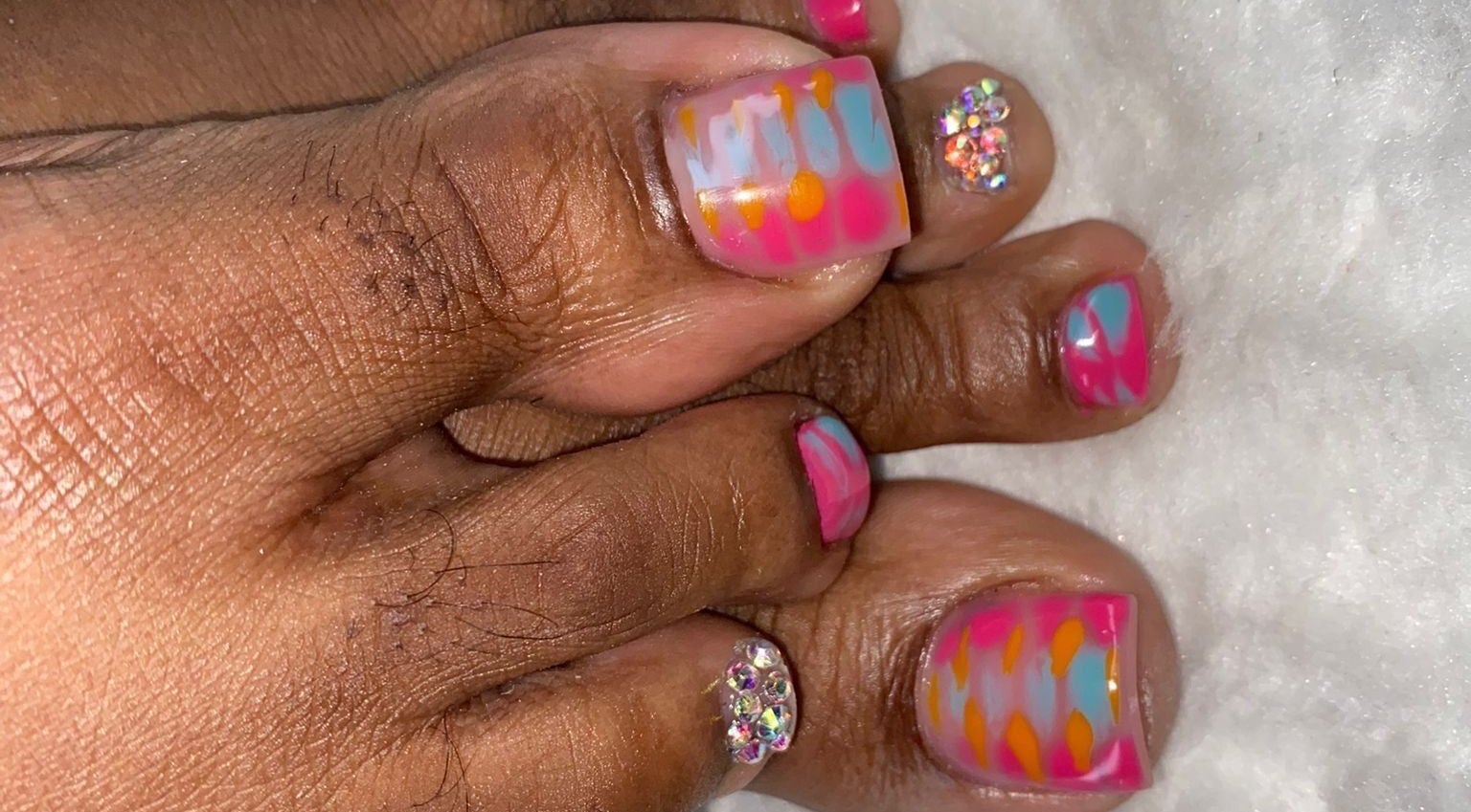 Colorful toenail art at Ccallicosmetics in Speightstown, Saint Peter, BB, featuring pink, orange, and blue designs.