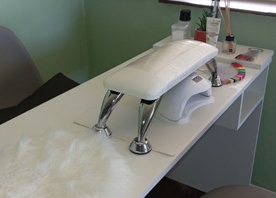 Nail service desk with tools at Lashed_byRosy in Cape Town, ZA, offering a serene setting.