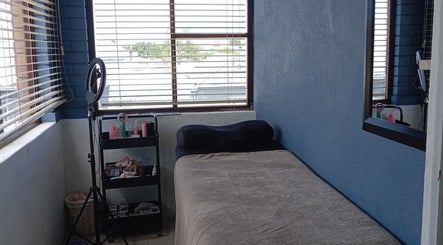 Cozy treatment room at Lashed_byRosy, Cape Town, ZA with soft bed and beauty tools under natural light.