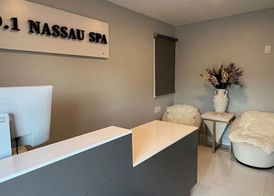 Reception area at No.1 Nassau Spa, Syosset, New York, US with cozy seats and elegant decor.