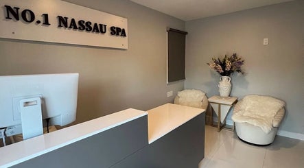 Reception area at No.1 Nassau Spa, Syosset, New York, US with cozy seats and elegant decor.