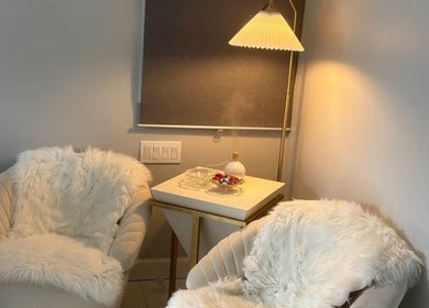Luxurious spa seating area at No.1 Nassau Spa in Syosset, New York, US, featuring plush chairs and soft lighting.