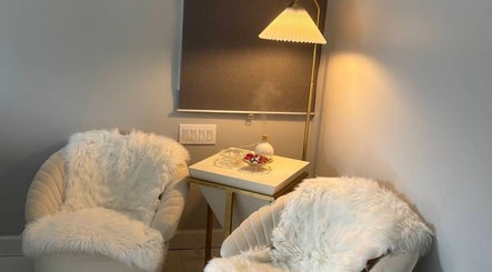 Luxurious spa seating area at No.1 Nassau Spa in Syosset, New York, US, featuring plush chairs and soft lighting.