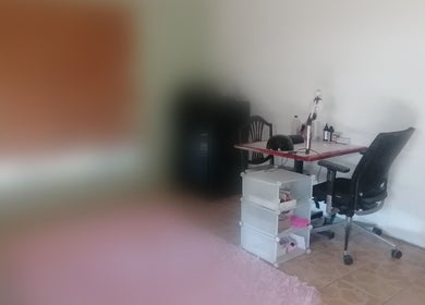 Nail station at Qadi's Nail Lounge in Cape Town, Western Cape, ZA featuring a desk and beauty products.