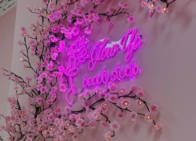 Pink neon sign 'Glow Up Beauty Studio' with cherry blossoms in Dublin, County Dublin, IE.