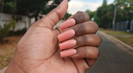 Coral manicured nails seen at Leko Nails, Midrand, Gauteng, ZA, showcasing precision and style.