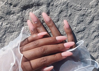 Close-up of elegant pink nails from Leko Nails, Midrand, Gauteng, ZA on textured background.