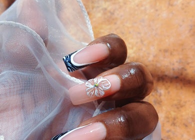 Stylish floral nail design at Leko Nails, Midrand, Gauteng, ZA, featuring intricate black and white patterns.