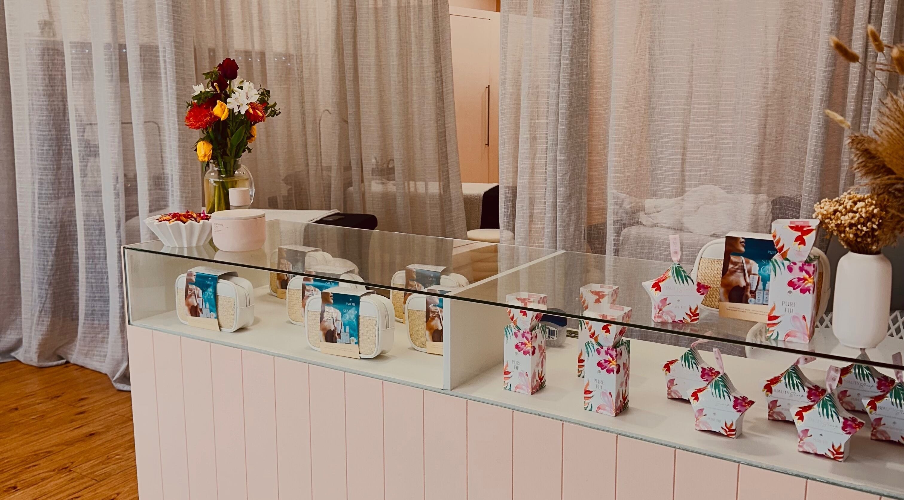 Elegant product display at Glo & Go, Taupō, Waikato Region, NZ with floral decor and beauty products.