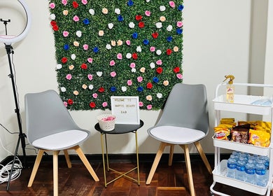 Seating area with floral wall at Happy’s Beauty Bar, Pretoria, Gauteng, ZA.