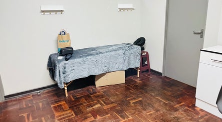 Serene treatment room at Happy's Beauty Bar in Pretoria, Gauteng, ZA, featuring a treatment bed and calming decor.