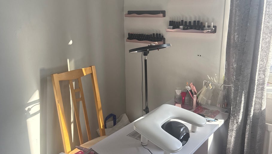 Nail workspace at Nails by MG in Howden-le-wear, England, GB, showcasing tools and polish on shelves.