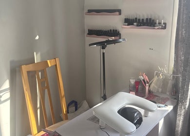 Nail workspace at Nails by MG in Howden-le-wear, England, GB, showcasing tools and polish on shelves.