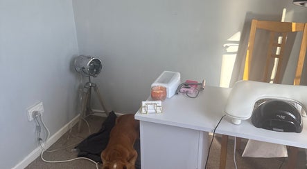 A cozy nail station at Nails by MG in Howden-le-wear, England, GB with nail tools and a lamp.