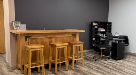 Welcoming interior of The B.A. Beauty Co. in Rifle, Colorado, US, featuring a wooden bar and seating.