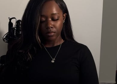 Relaxed individual with long hair at Saniyah Stylez, Philadelphia, US, highlighting calm ambiance.