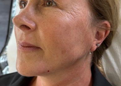 Close-up of a woman showcasing her radiant complexion at Glow With Grace, Banbury, England, GB.