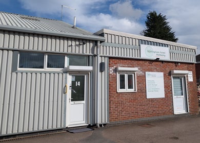 Front view of Rockingham Forest Wellbeing in Corby, England. Entrance and signage visible.
