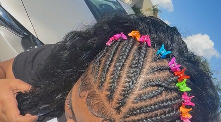 Colorful braided hairstyle with butterfly clips at IcedbyN, Fort Myers, Florida, US.