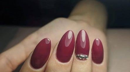 Manicura elegante en Uñitas Fashion, Lanús, Provincia De Buenos Aires, AR, con diseño bordó y pedrería.