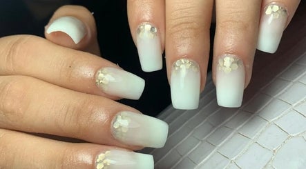 Manicura elegante en Uñitas Fashion, Lanús, Provincia De Buenos Aires, AR con diseño blanco y detalles dorados.