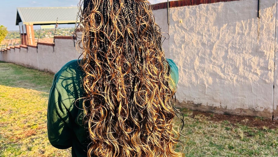 Lush, golden curls styled at Hairbylue in Midrand, Gauteng, ZA, showcasing expert hair artistry.
