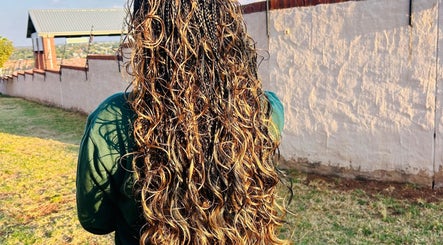 Lush, golden curls styled at Hairbylue in Midrand, Gauteng, ZA, showcasing expert hair artistry.