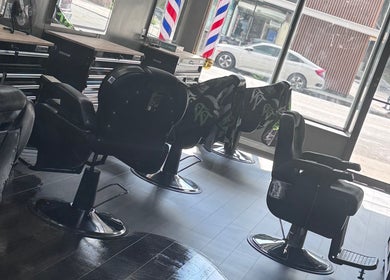 Modern barber chairs at JYSBARBER.PRO in Yonkers, New York, US, showcasing a sleek and inviting interior.