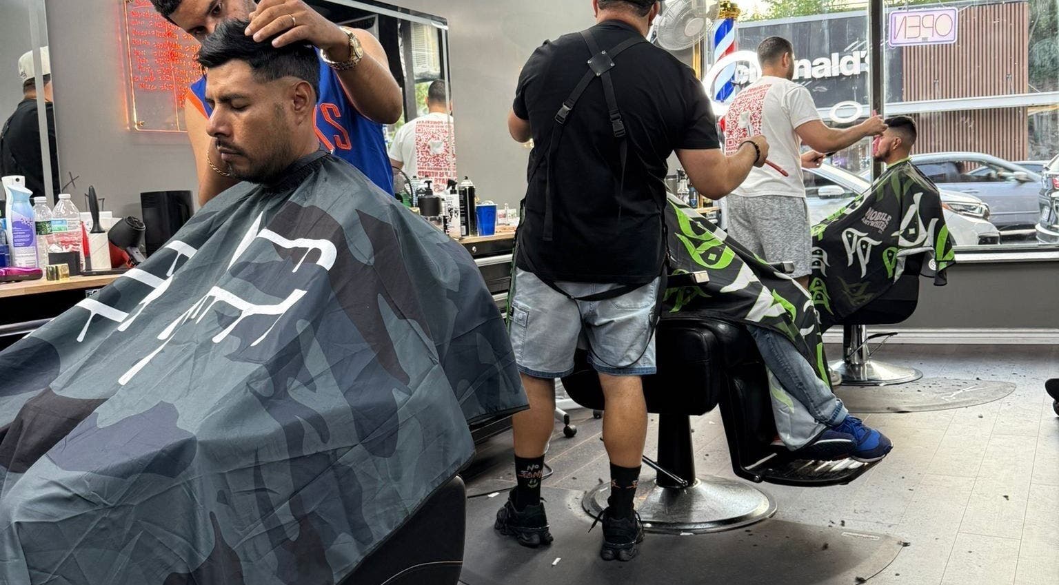 Barbers creating stylish cuts at JYSBARBER.PRO, Yonkers, New York, US.