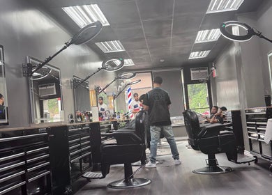 Contemporary barber shop interior at JYSBARBER.PRO in Yonkers, New York, US with stylish chairs and mirrors.