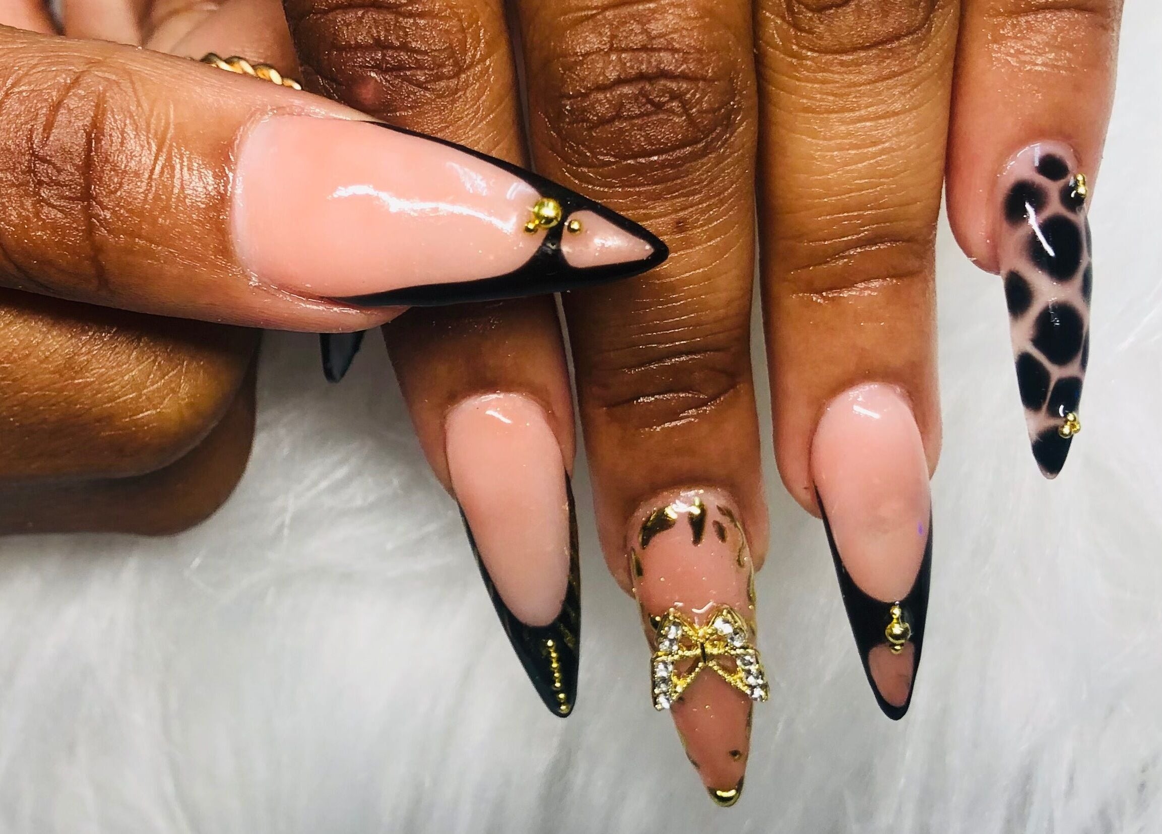 Elegant nail art at Nailed by Mandy, Katlehong, Gauteng, ZA, featuring gold accents and leopard print.