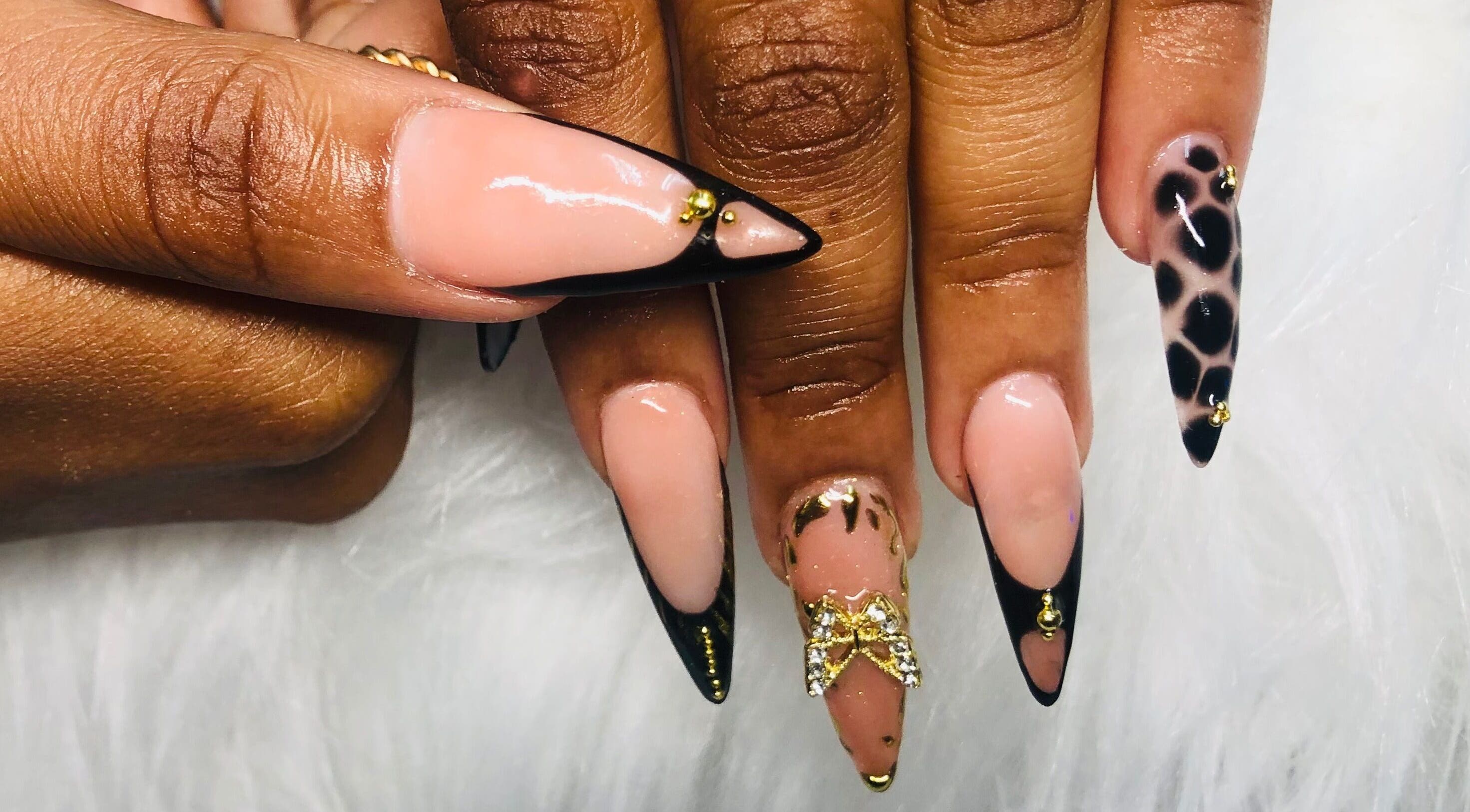 Elegant nail art at Nailed by Mandy, Katlehong, Gauteng, ZA, featuring gold accents and leopard print.