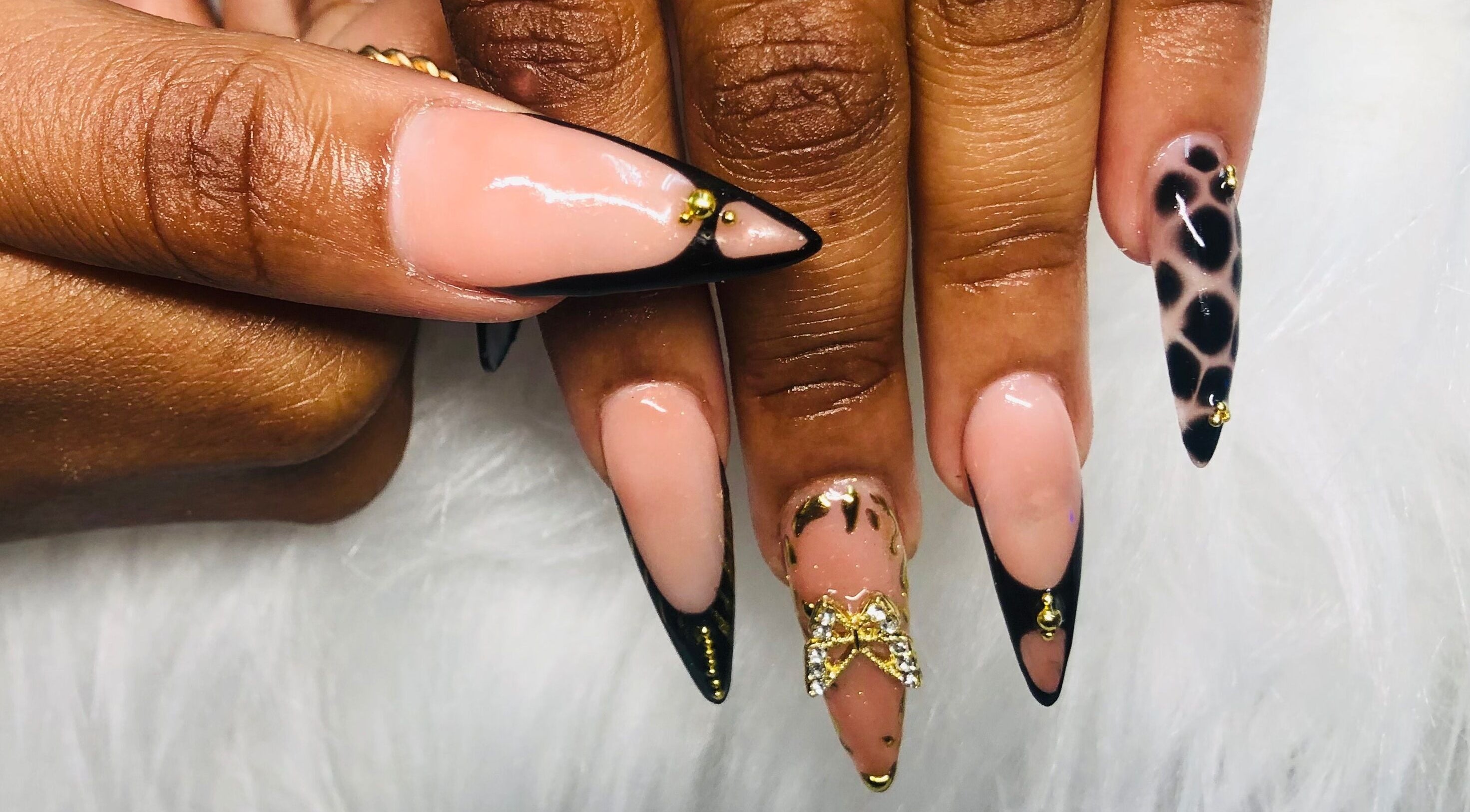 Elegant nail art at Nailed by Mandy, Katlehong, Gauteng, ZA, featuring gold accents and leopard print.