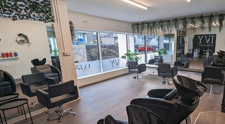 Modern salon interior at Inspired Hair Design, Uphall Station, Scotland, GB with sleek chairs and mirrors.