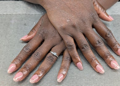 Beautifully manicured hands with soft pink nails at Starz & Knyvz Nails, Beaconsfield, England, GB.