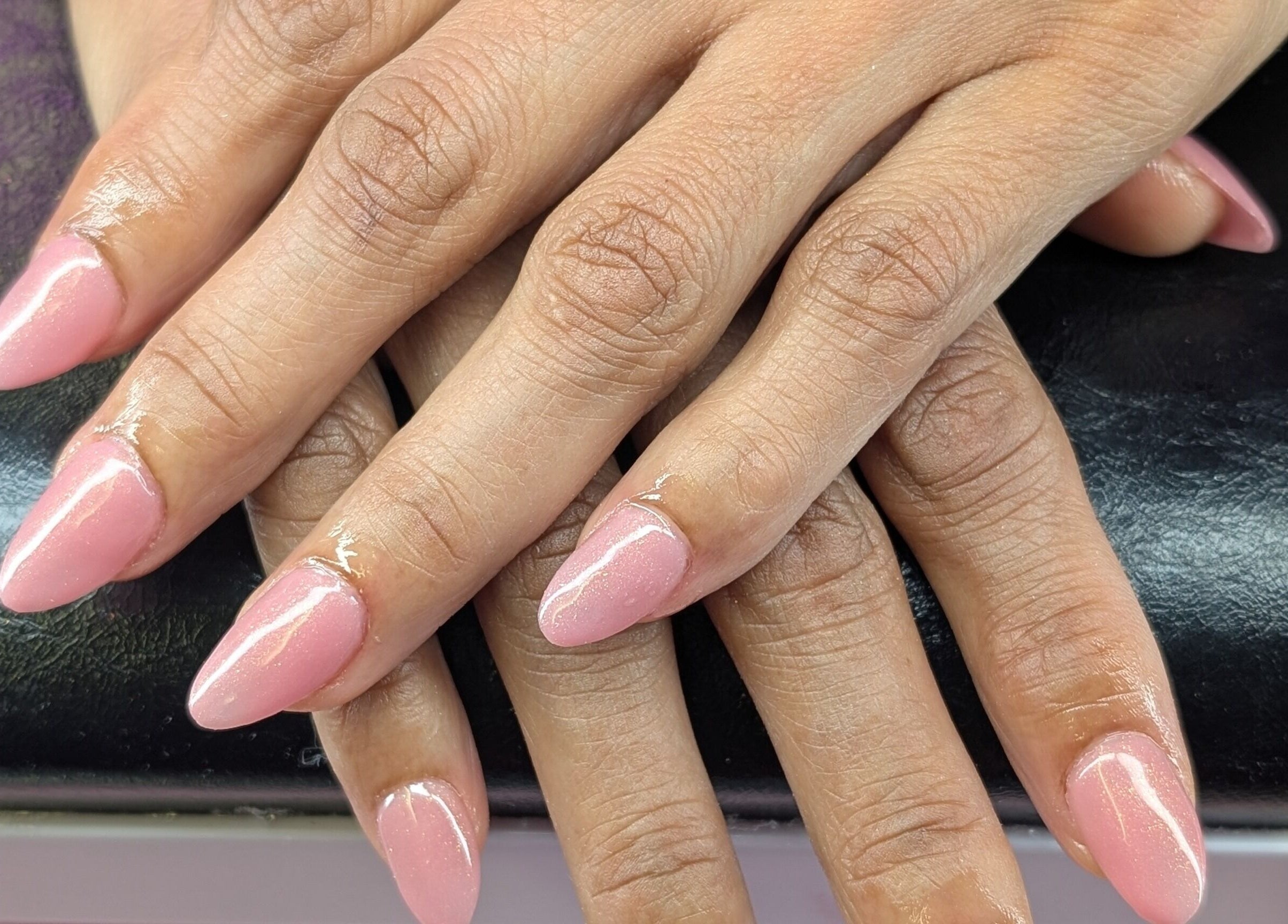 Pink manicured nails at Starz & Knyvz Nails, Beaconsfield, England, GB showcasing elegant style.