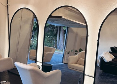 Chic interior of Salon LOTI in Newry, Northern Ireland, GB, featuring modern mirrors and stylish chairs.